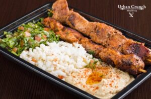 Marinated chicken kabob with tabouli, rice and hummus