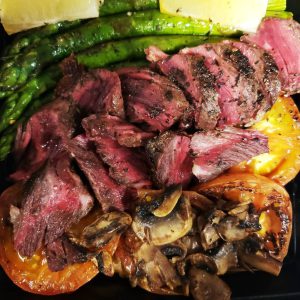 Seared hanger steak with roasted tomatoes, mushroom and asparagus